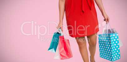 Composite image of woman standing with shopping bags