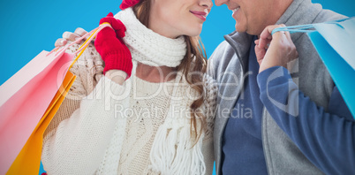 Composite image of couple with shopping bags