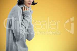 Composite image of woman in winter clothing posing against white background