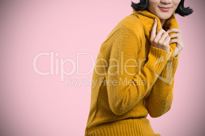 Composite image of woman in winter clothing posing against white background