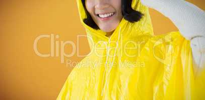 Composite image of woman wearing yellow raincoat against white background