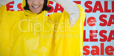 Composite image of woman wearing yellow raincoat against white background
