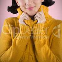 Composite image of woman in winter clothing posing against white background