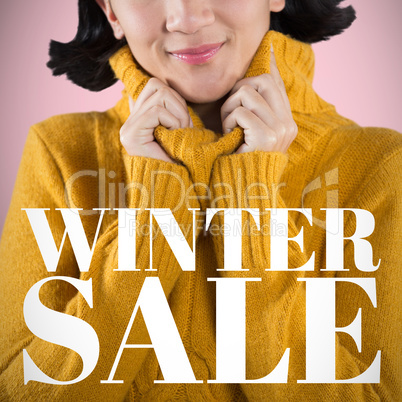 Composite image of woman in winter clothing posing against white background