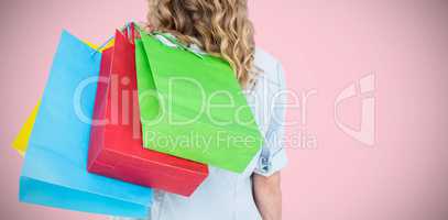 Composite image of woman holding some shopping bags