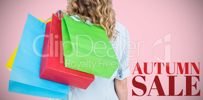 Composite image of woman holding some shopping bags