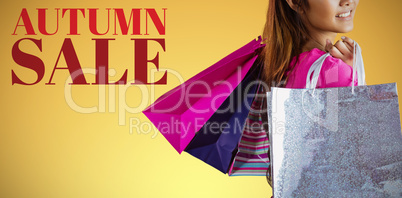 Composite image of smiling asian woman with shopping bags