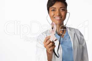 Female doctor holding a pink ribbon and a stethoscope