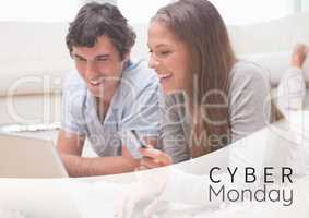 Cyber Monday Sale Couple lying in front of laptop with creditcard in her hand