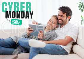Cyber Monday Sale Man and Woman sitting on a couch with their tablet