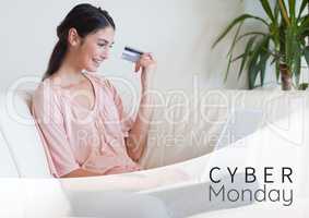Cyber Monday Sale Woman sitting in front of laptop with creditcard in her hand