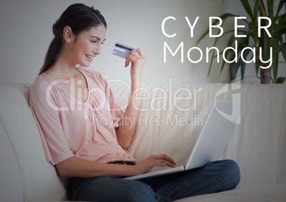 Cyber Monday Sale Woman sitting in front of laptop with creditcard in her hand