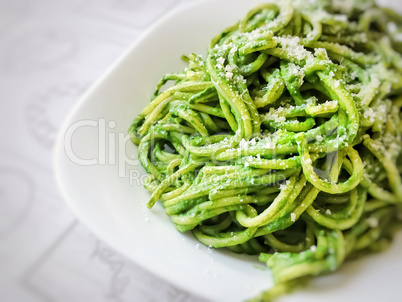 Close up view of spaghetti cooked with a green homemade sauce