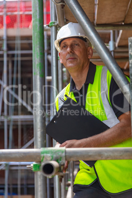 Construction Foreman Builder on Building Site With Clipboard