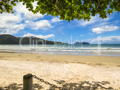 View of seaside in sunny day, with blue sky, and white clouds.