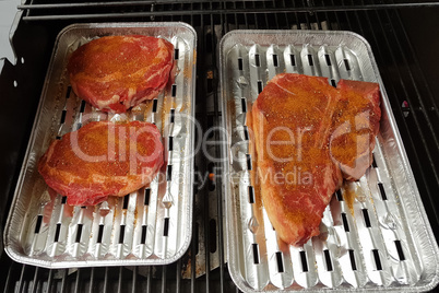 Beef and steaks on the grill with flames