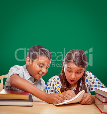 Blank Chalk Board Behind Hispanic Boy and Girl Having Fun Studyi