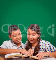 Blank Chalk Board Behind Hispanic Boy and Girl Having Fun Studying