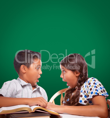 Blank Chalk Board Behind Hispanic Boy and Girl Having Fun Studyi