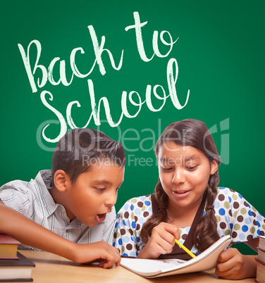 Back To School Written On Chalk Board Behind Hispanic Boy and Gi