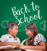 Back To School Written On Chalk Board Behind Hispanic Boy and Girl