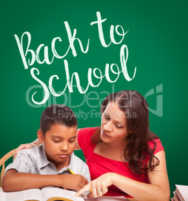 Back To School Written On Chalk Board Behind Hispanic Young Boy and Tutor