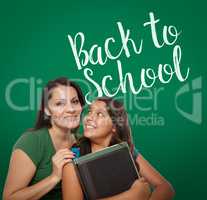 Back To School Written On Chalk Board Behind Proud Hispanic Mom