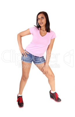 Woman in jeans shorts standing bending