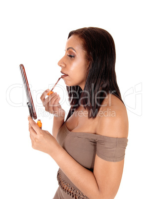 Woman putting color on her lips