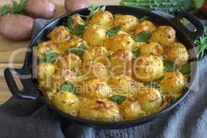 Young potatoes with cottage cheese are baked in the oven.