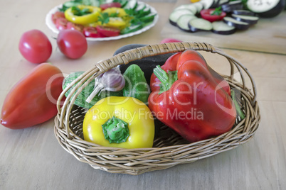 Vegetables on the table in a wicker basket.