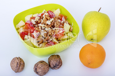 Fruit bowl with sliced apples oranges and nuts