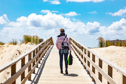 Woman on the wooden pier to the sea