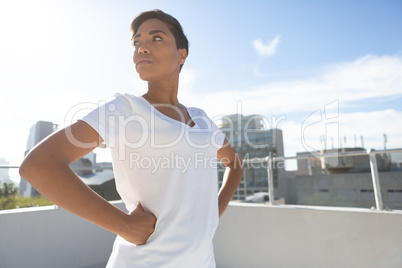 Side view of confident woman standing for breast cancer awareness