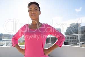 Serious looking woman standing confident for breast cancer awareness