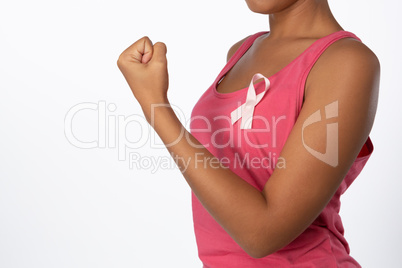 Mid section of woman with pink ribbon for breast cancer awareness