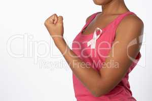 Mid section of woman with pink ribbon for breast cancer awareness