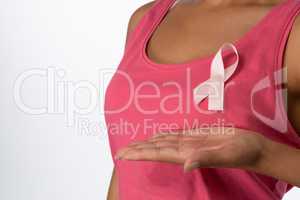Woman showing pink ribbon for breast cancer awareness