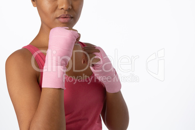 Mid section of woman with gloves for breast cancer awareness