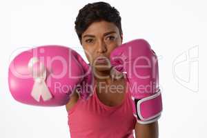 Woman in boxing gloves fighting against breast cancer
