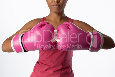 Woman for breast cancer awareness with ribbon in boxing gloves