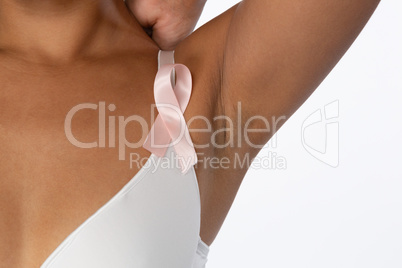 Woman for breast cancer awareness in white bra with pink ribbon