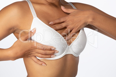 Standing woman for breast cancer awareness in white bra