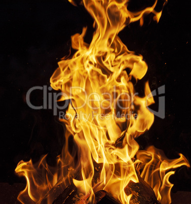 burning wooden logs and large orange flame