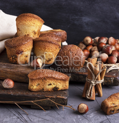 baked cupcakes with dried fruits on a wooden board