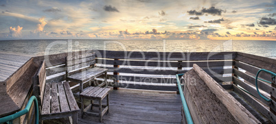 Bench overlooks the ocean at Vanderbilt Beach at sunset