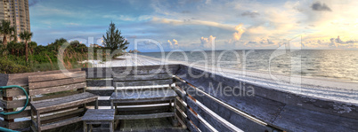 Bench overlooks the ocean at Vanderbilt Beach at sunset