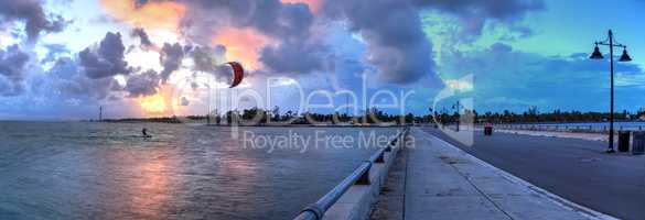 Kite surfer surfs alongside the Edward B. Knight Pier at sunset