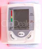 Automatic Wrist Digital blood pressure monitor on pink backgroun