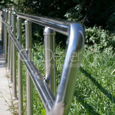 metal fence in park at dry sunny summer day